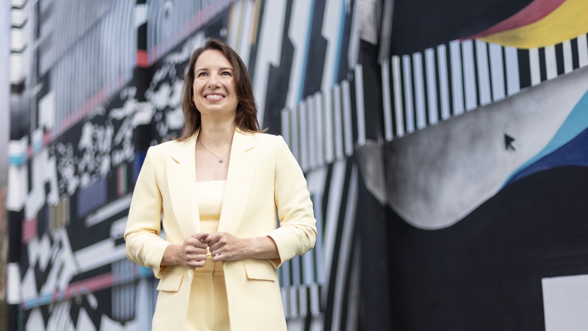 Marketa Rickley of UNCG BSBE stands on front of a colorful background.