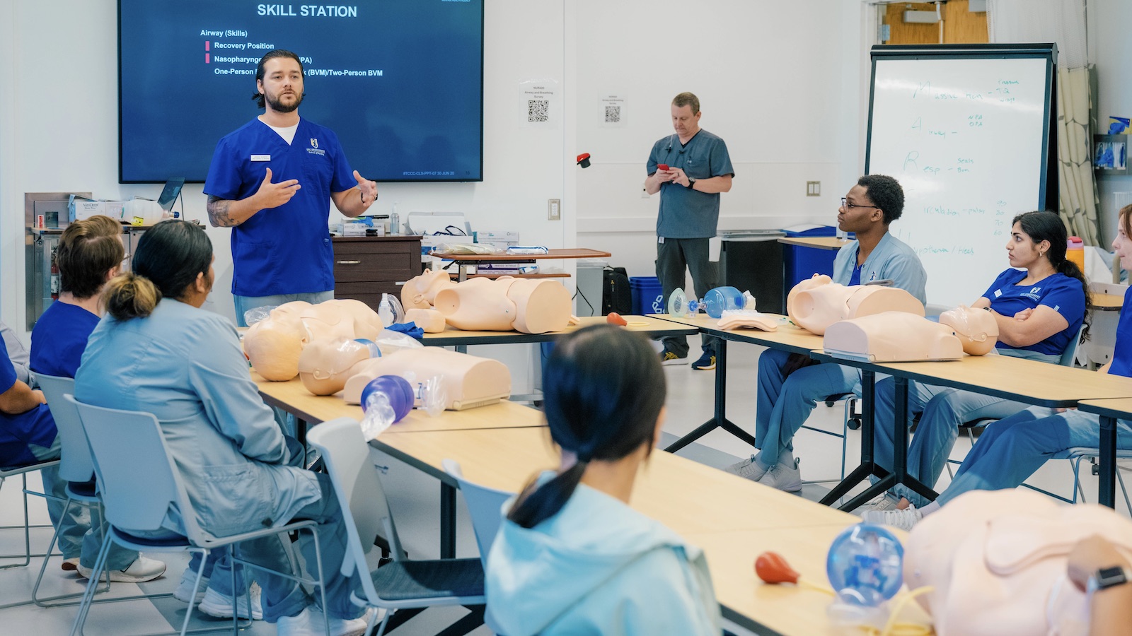UNCG School of Nursing students learning in the classroom with AI stimulation and powerpoint presentations. 