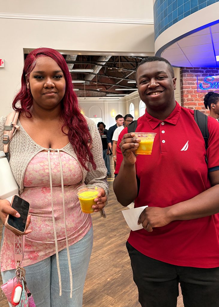 UNCG students holding smoothies.