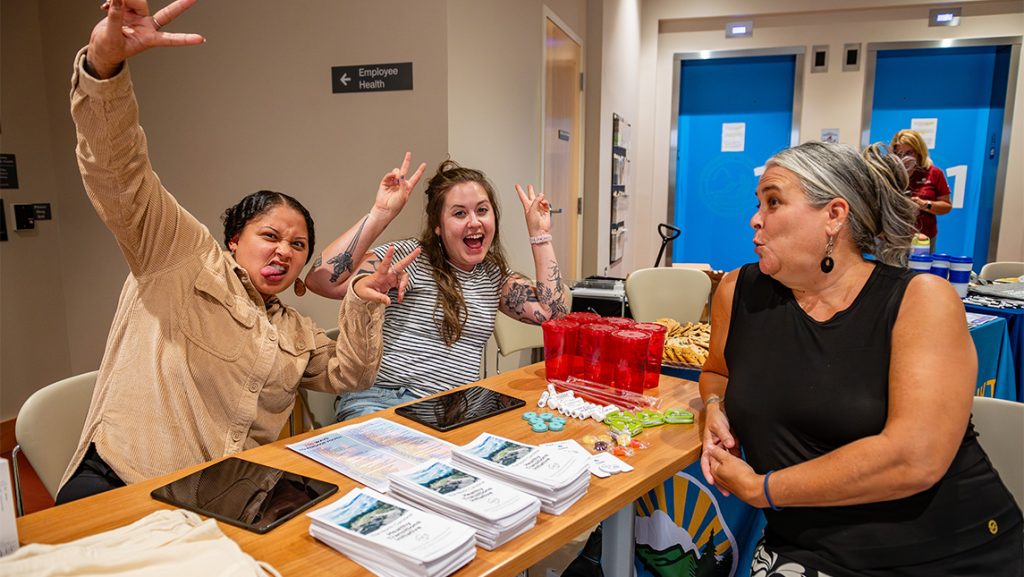 CYFCP staff make faces at a table.