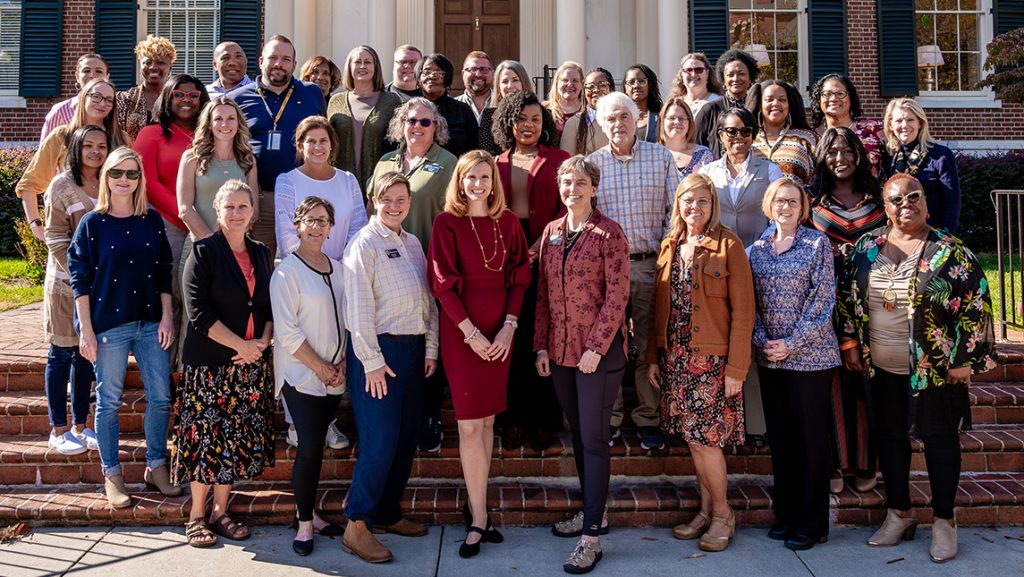 CYFCP team takes a group photo outside UNCG Alumni House.