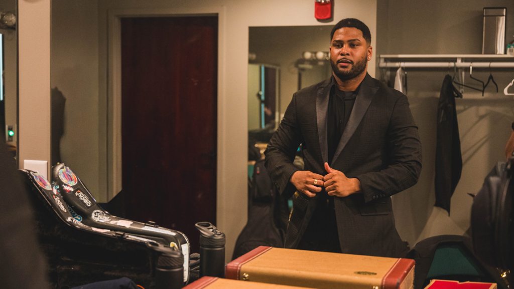 Franco Romero straightens his suit backstage.