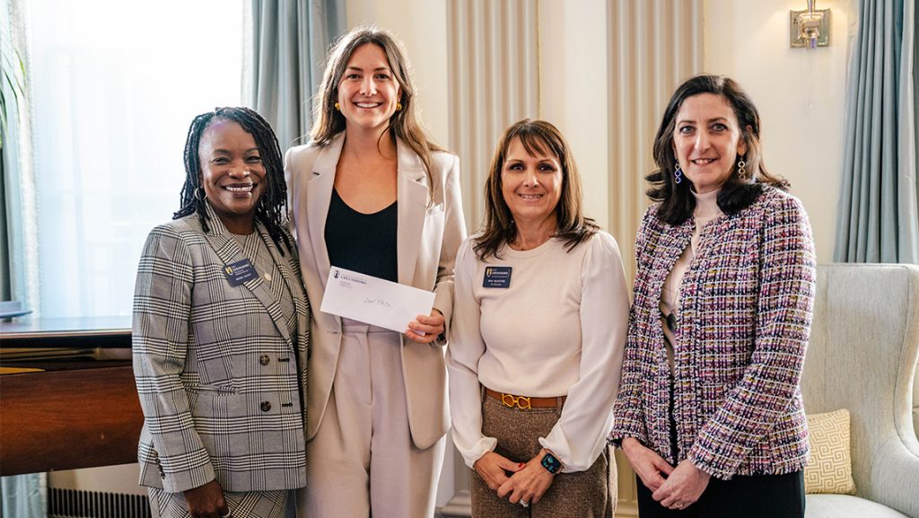 UNCG nutrition student Victoria Fonville poses with Three Minute Thesis judges.