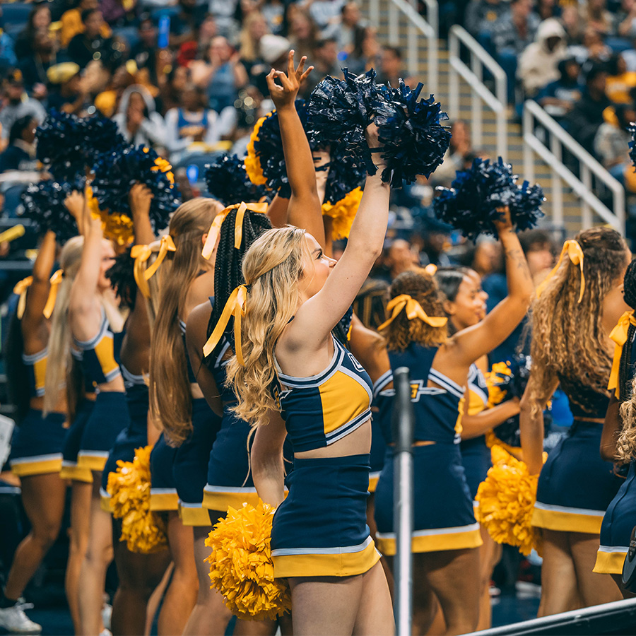 UNCG cheerleaders on the sidelines.