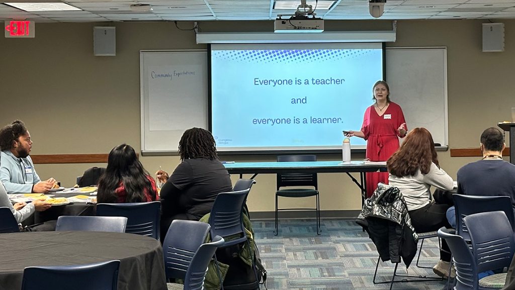 A UNCG lecture with a projector slide.