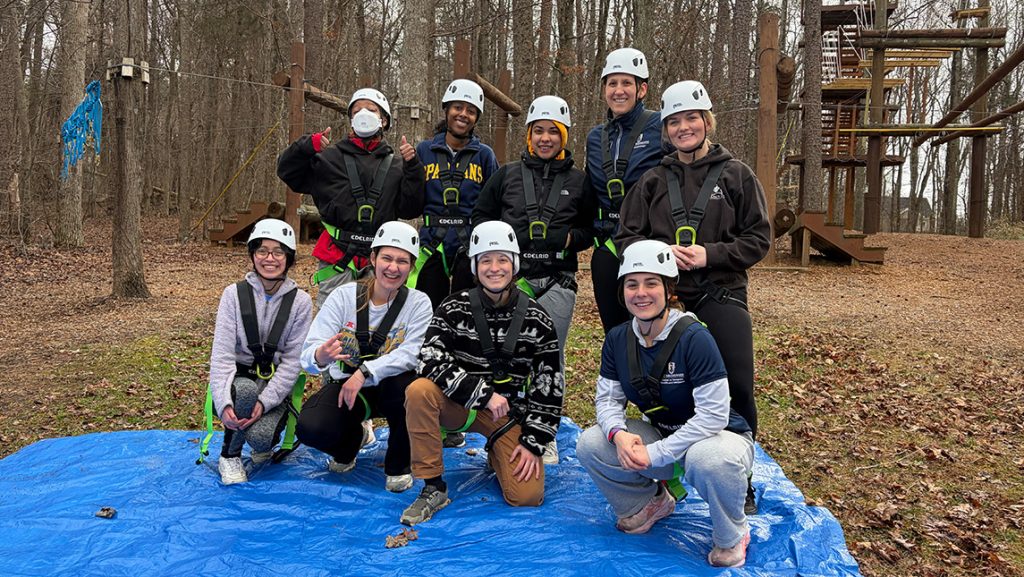 UNCG students wearing climbing gear outside.