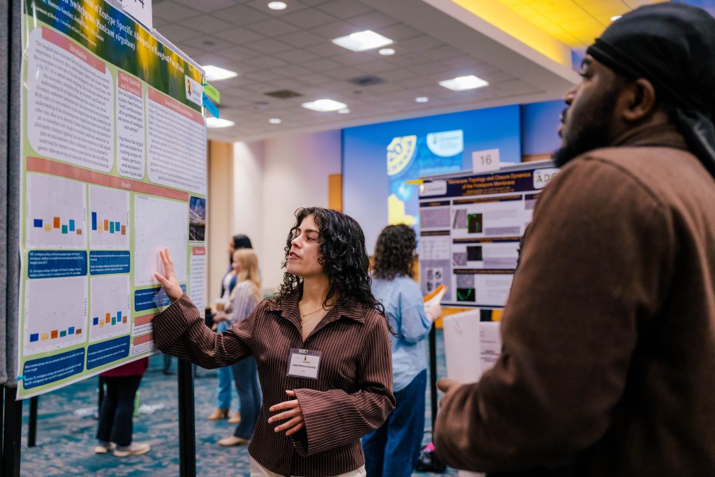 Students present their research posters to expo attendees