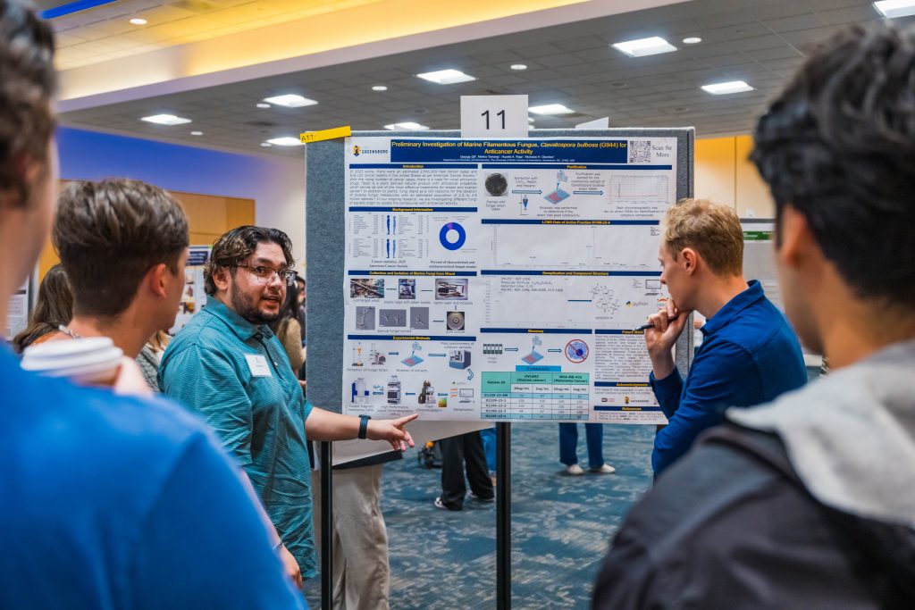 Students present their research posters to expo attendees