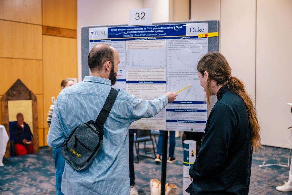 Students present their research posters to expo attendees