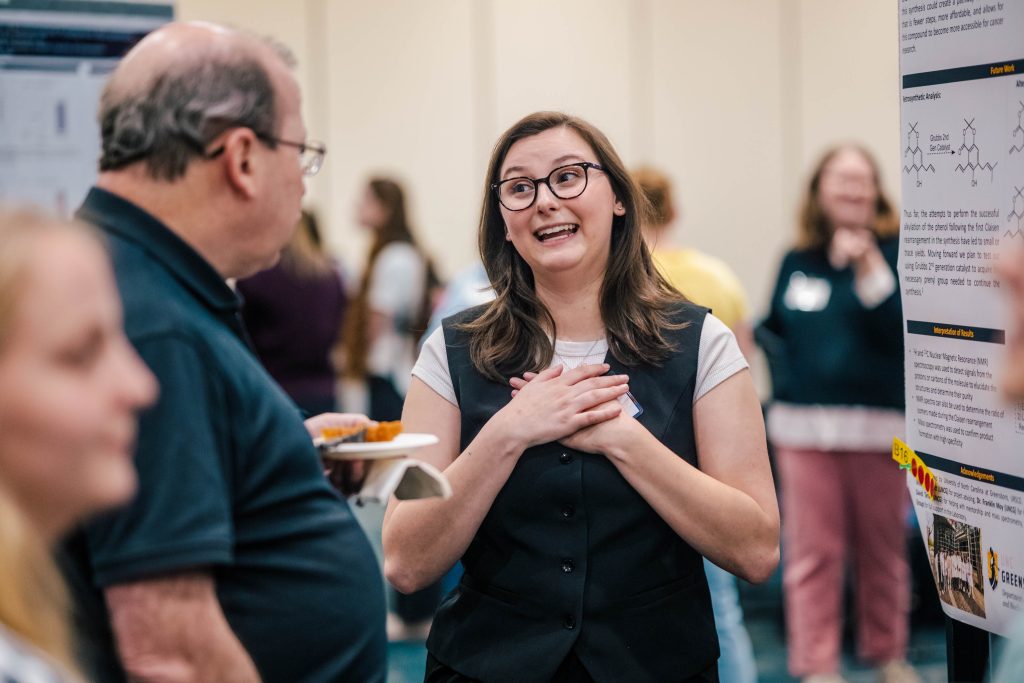 Students present their research posters to expo attendees
