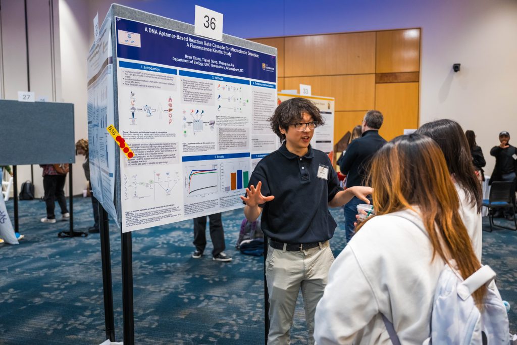 Students present their research posters to expo attendees