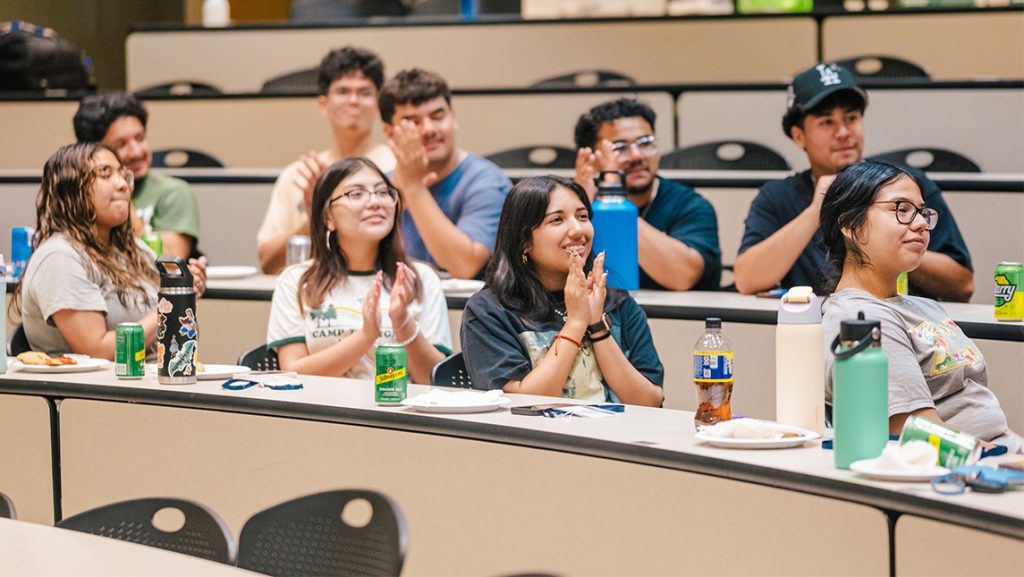 High school students laugh during a lecture.