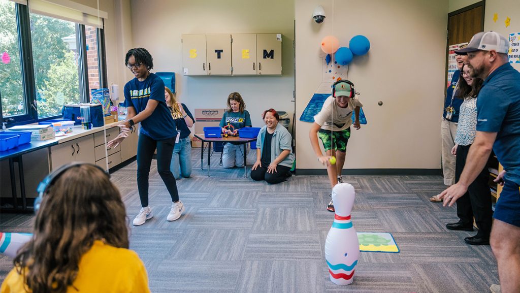 Children play a game in a classroom.