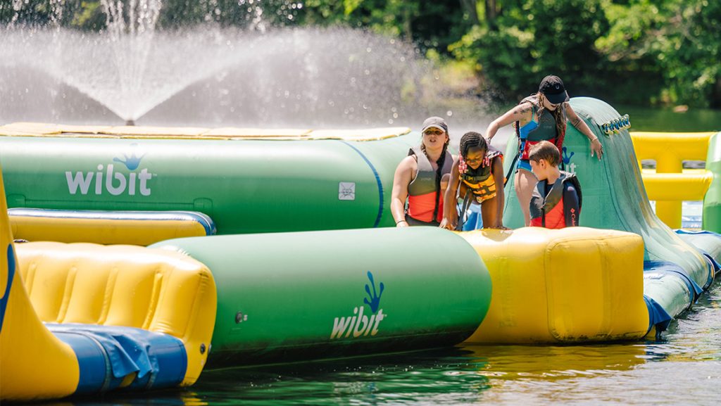 Children play on the inflatables on Piney Lake.