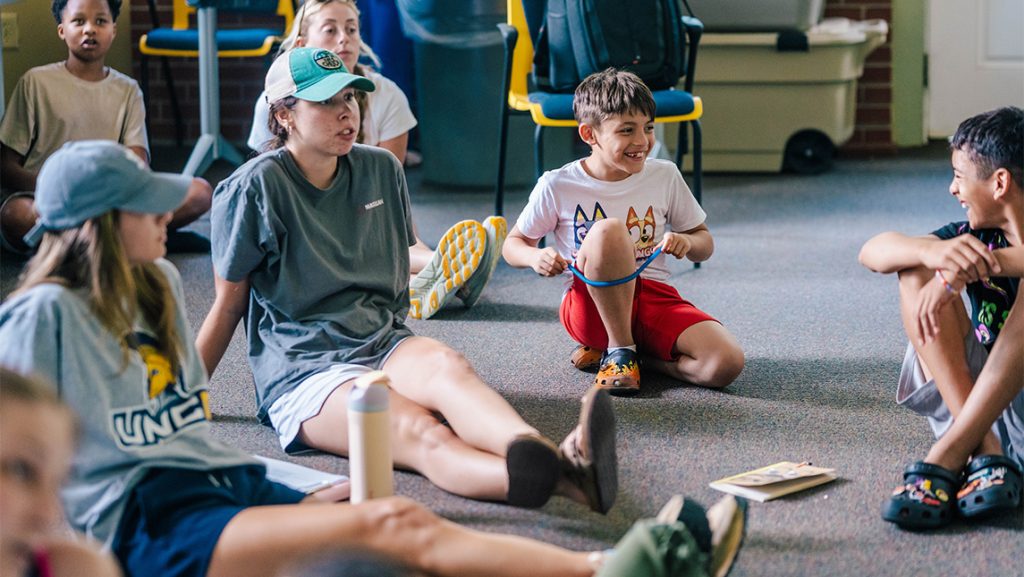 Children play on a UNCG classroom floor.