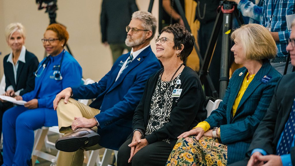 UNCG Provost Alan Boyette and Greensboro Mayor Marikay Abuzuaiter sit on steps.