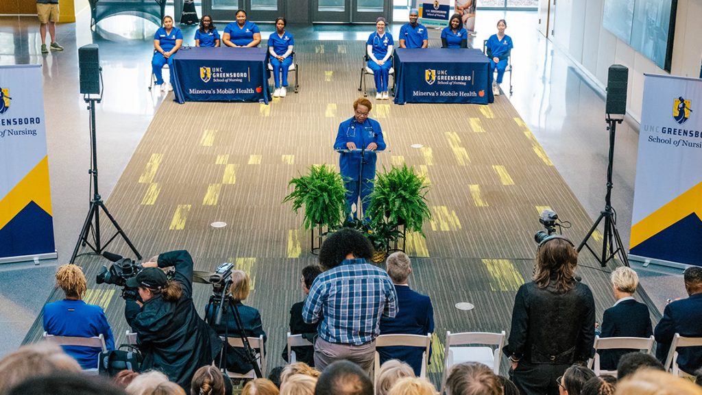 UNCG Nursing Dean Debra Barksdale speaks to a crowd at a podium.