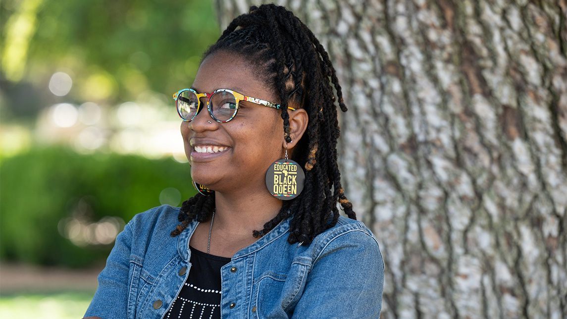 Portrait of Shameeka Wilson outside beside a tree.