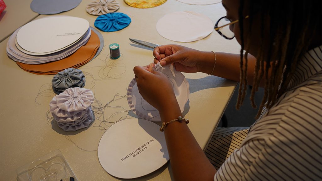 Closeup on a yo-yo fabric circle.