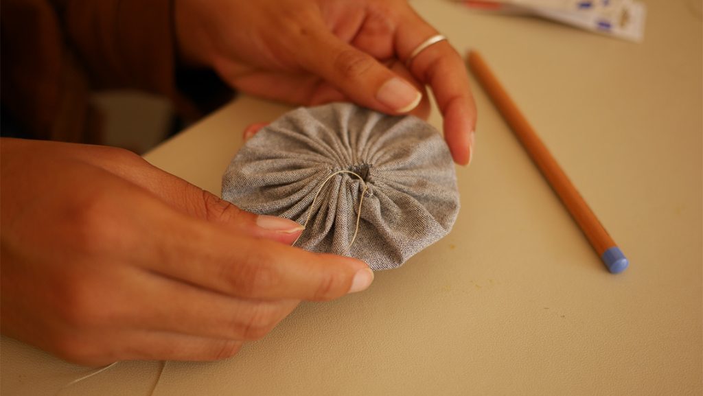 Closeup on a yo-yo fabric circle.