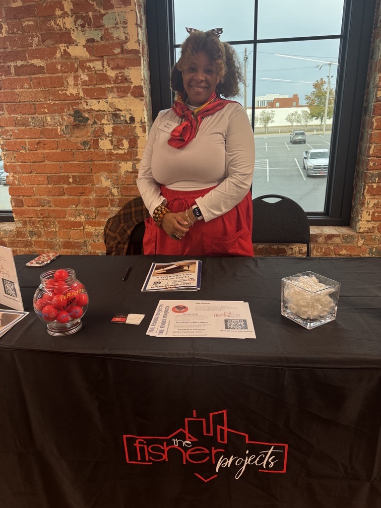 Blakely tabling at an event to share information about The Fisher Projects.