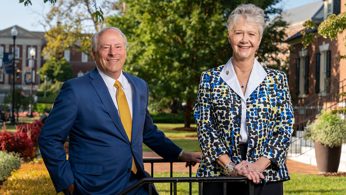 Randall Kaplan and Susan Safran stand on steps of UNCG Marcus T. Johnson Alumni house.
