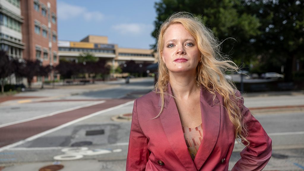 UNCG professor Madelynn Stackhouse stands outside the Bryan School building.