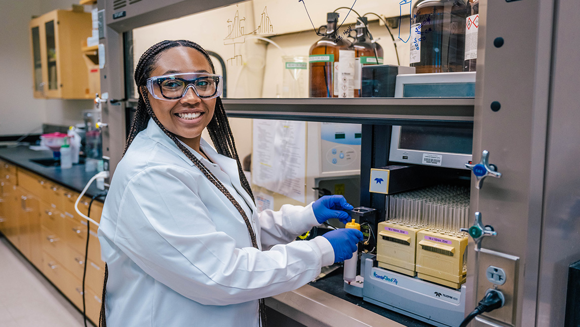 UNCG student Janae Wofford smiles while working in the lab.