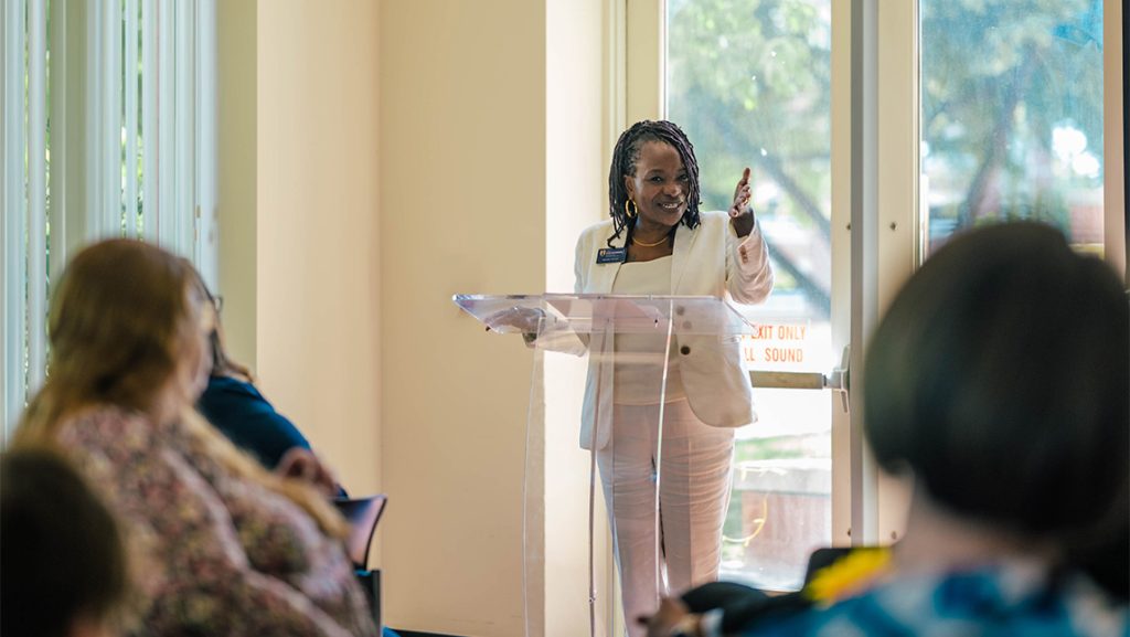 Provost Fellow Regina McCoy speaks at a podium.