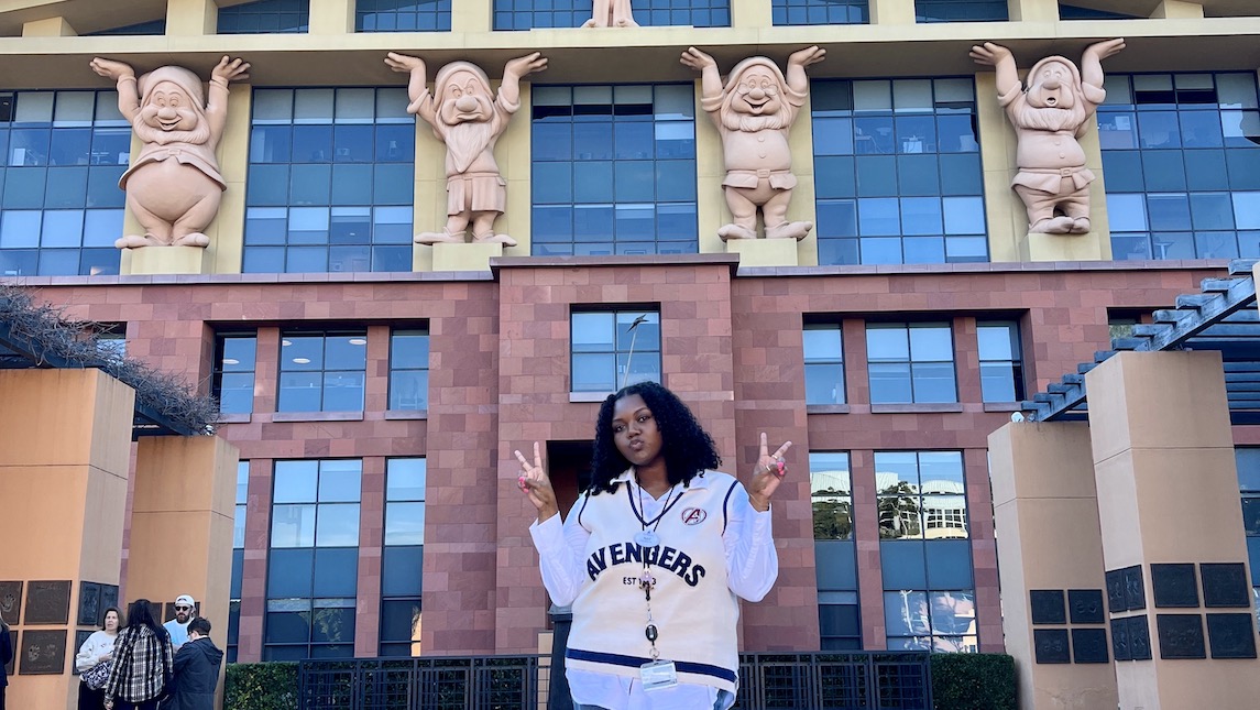 UNCG BSBE alumna, Natalie Tucker poses in front of Disney building.