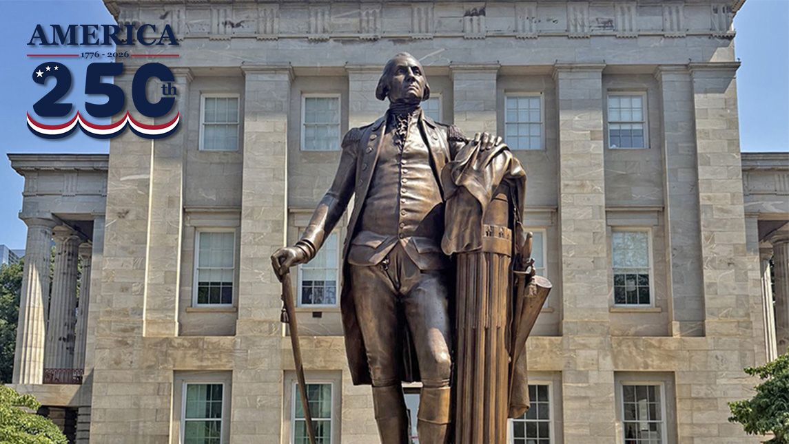 A bronze statue outside a historic building.