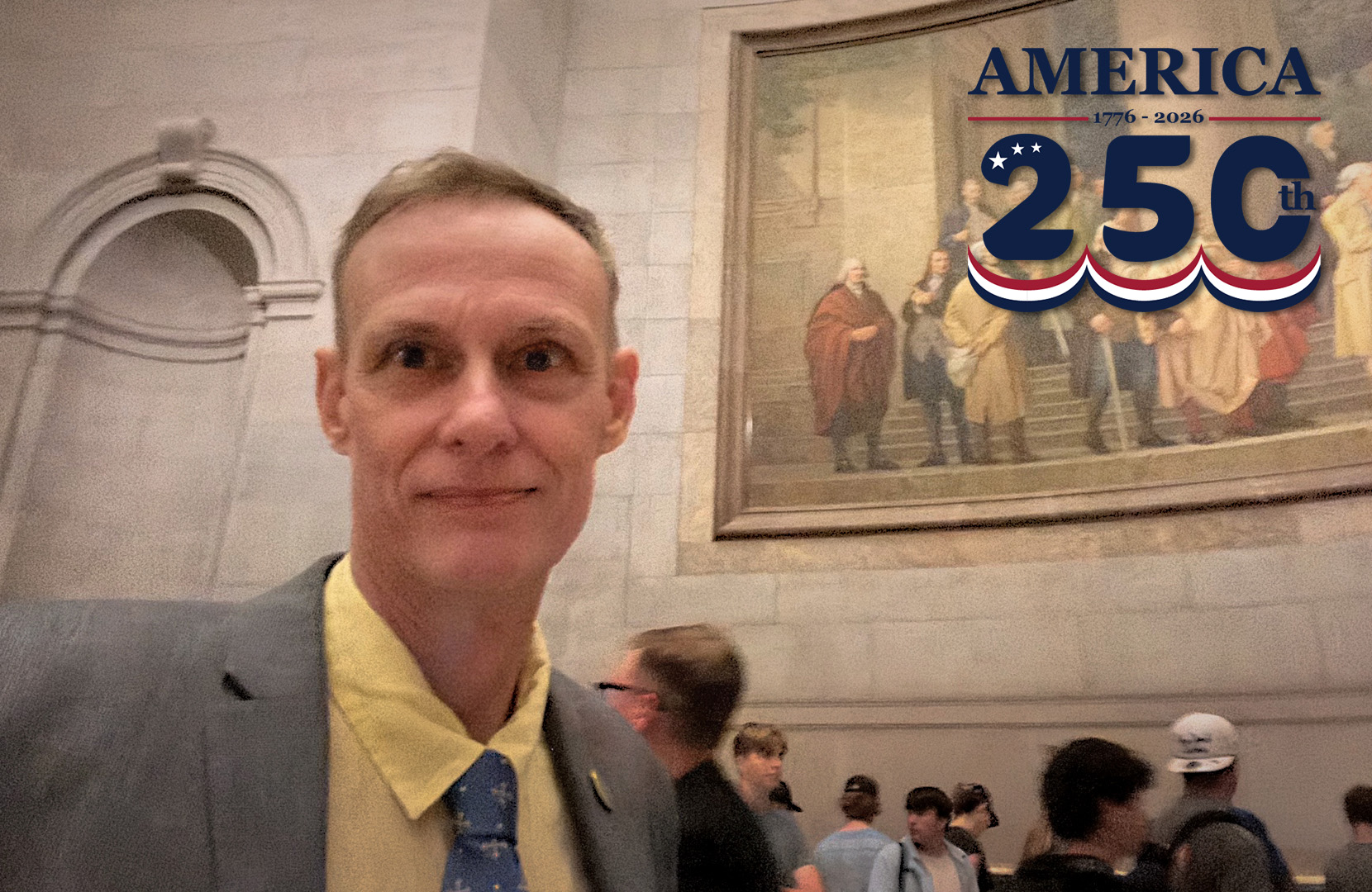 Ernest Dollar in front of a historic painting.