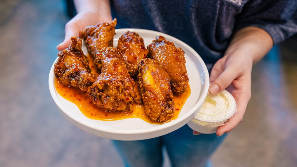 Close-up on a plate full of chicken wings.