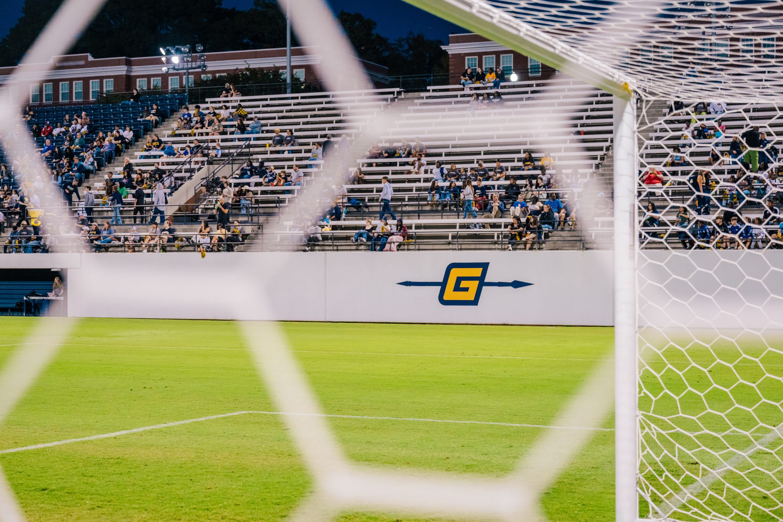 net blurred with a focus on the G on the outside of the soccer field