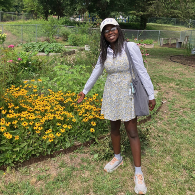 UNCG student stands in a local park.
