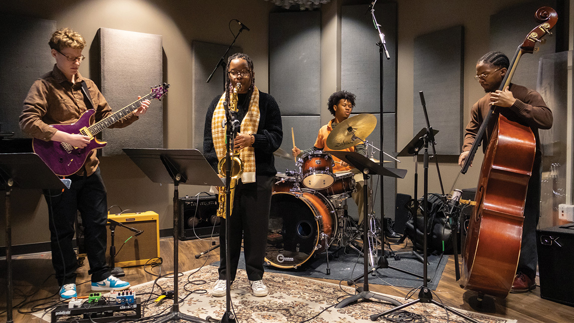 Four people perform in a jazz band.