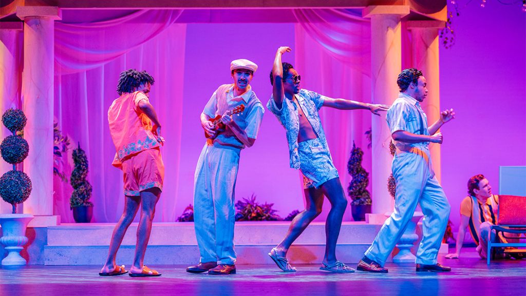 Four actors in beach costumes onstage.