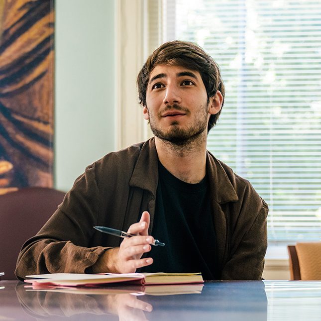 UNCG students Sophia Rosenberg and Ethan Divon talk during a meeting.