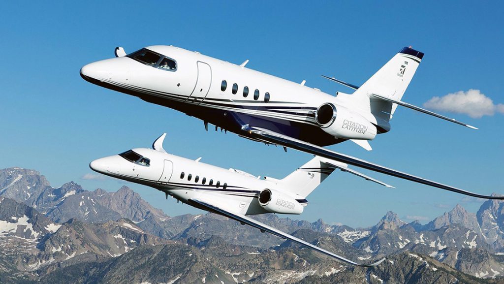 Two jets flying through the sky.