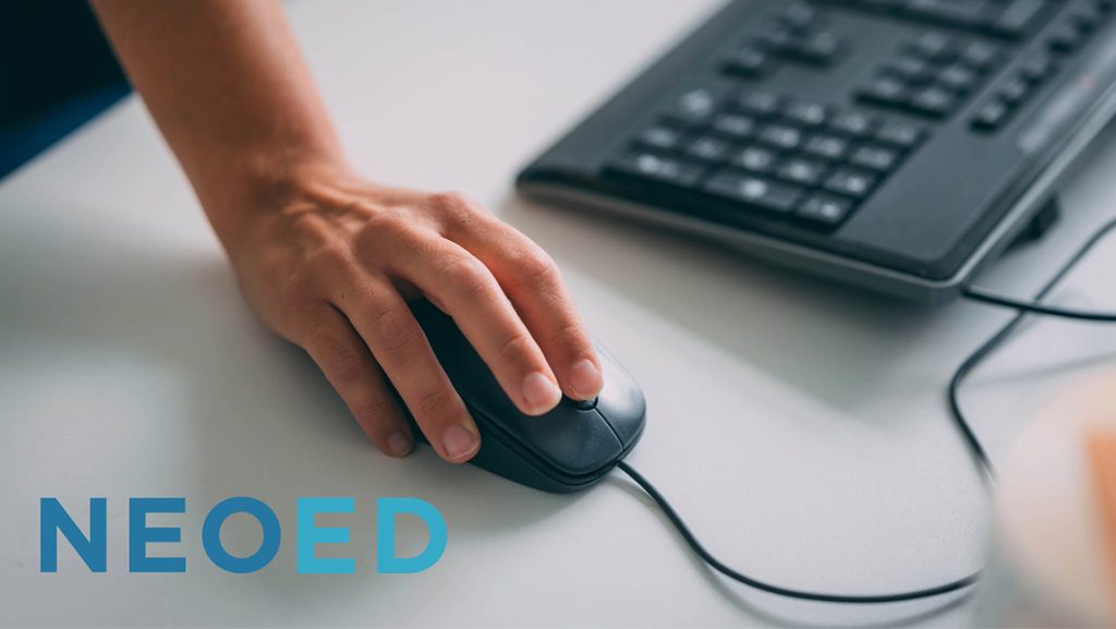 NeoEd logo over a hand moving a computer mouse next to a keyboard.