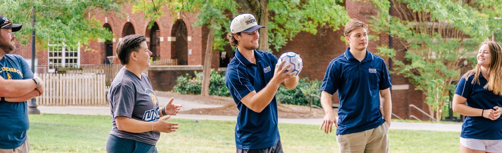 Kinesiology students discuss a team building exercise.