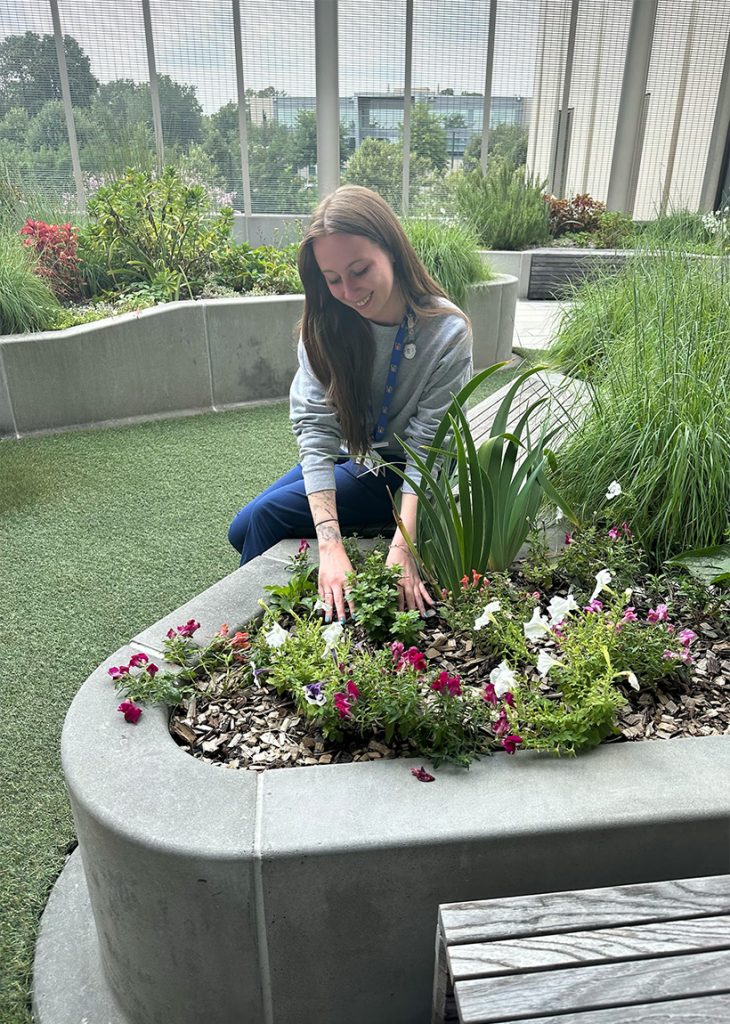 Belle Downing in an indoor garden.