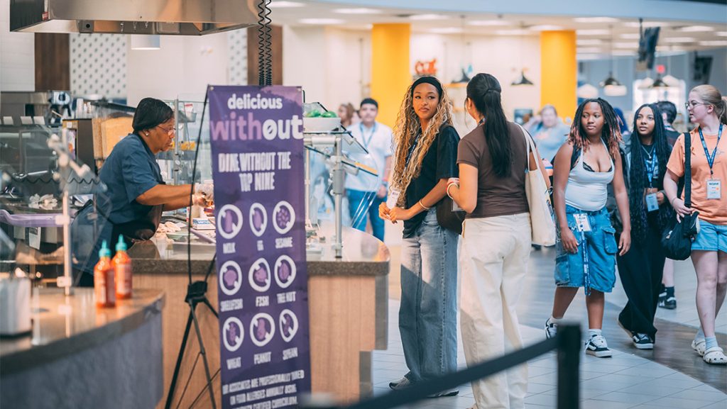Students line up for food in a college dining hall.