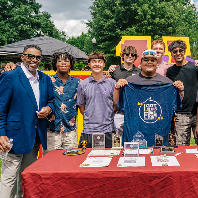 Students pose with Chancellor Gilliam at UNCG's fall kick off event.