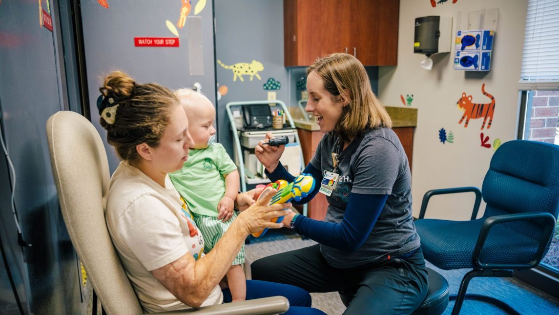 Dr. Sarah Stalnaker checks a baby's hearing.