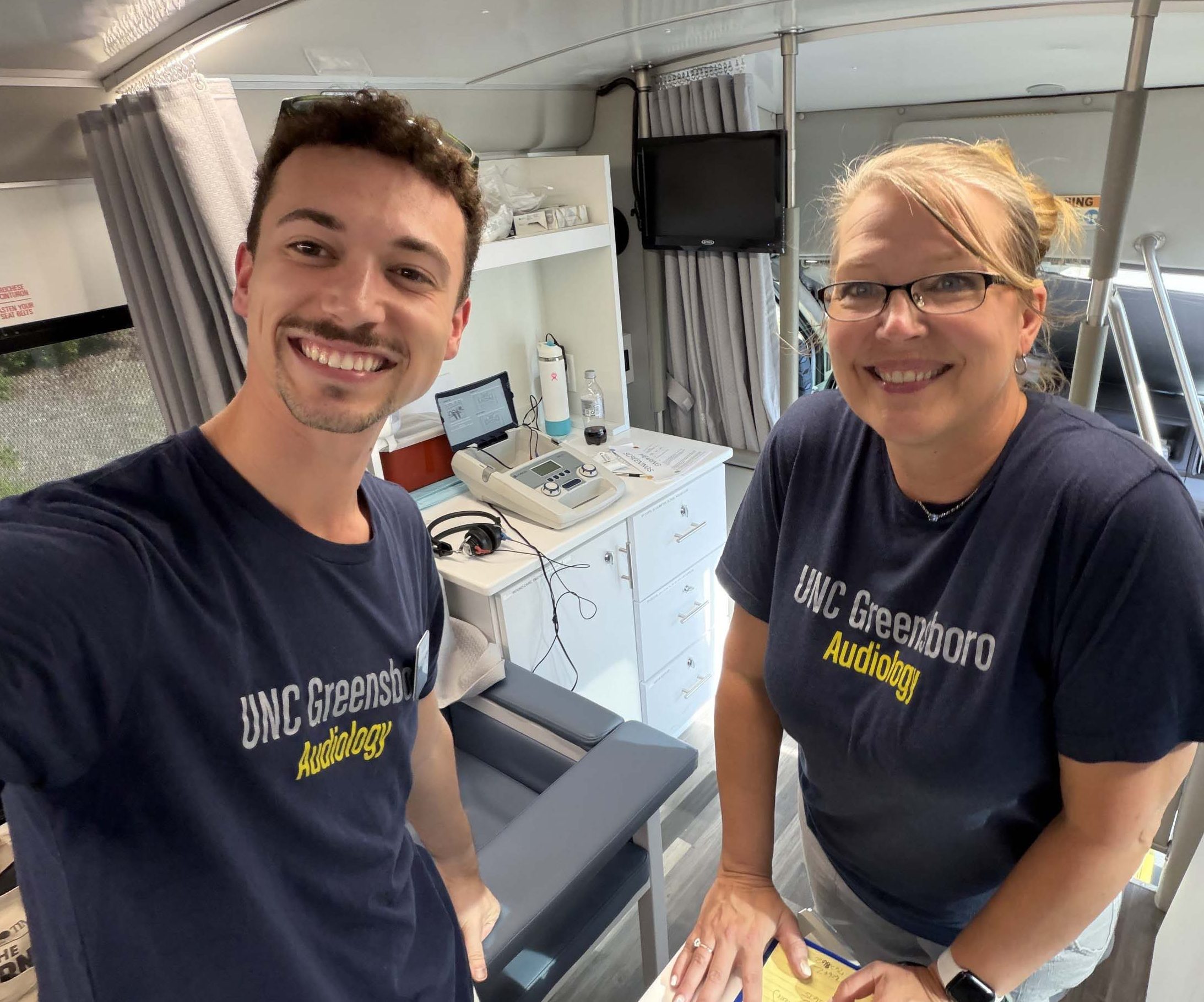 Trenton Barnett and Dr. Lisa Fox-Thomas conduct hearing screenings.