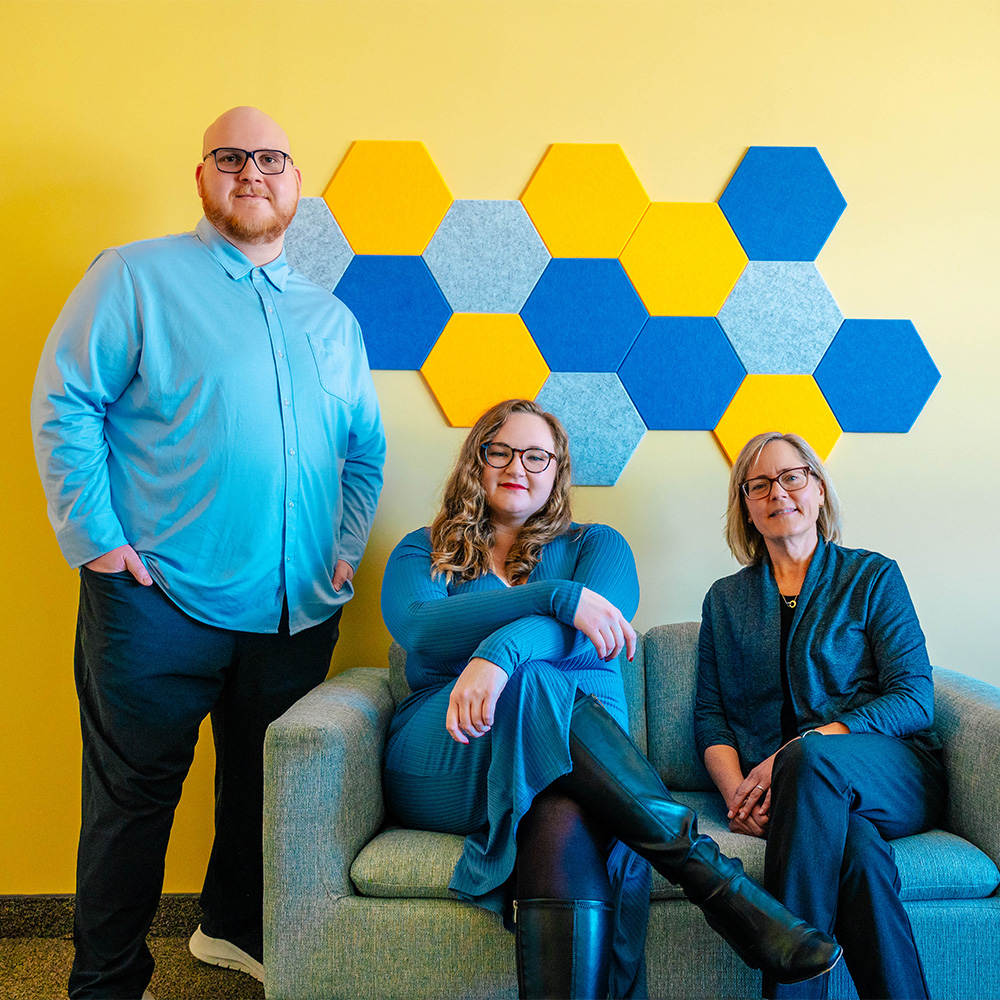 UNCG psychology doctoral students sit on a couch with Dr. Kari Eddington.