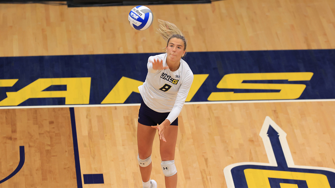 UNCG volleyball player Allie Sweet reaches for the ball on the court.